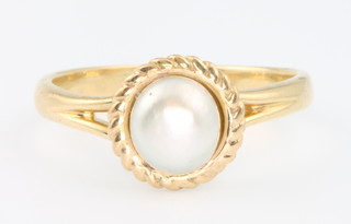 An 18ct yellow gold pearl set dress ring size L 1/2