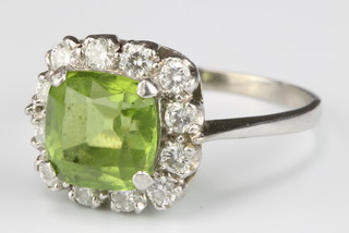 An 18ct white gold peridot and diamond cluster ring, size O 