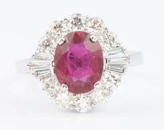 An 18ct white gold oval ruby and diamond cluster ring, the centre stone approx. 2.12ct, the diamonds approx 0.97ct  size M 