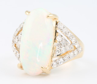 An 18ct yellow gold oval opal and diamond ring, the centre stone 6.0ct, the diamonds 0.65ct size O
