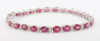 An 18ct white gold ruby and diamond bracelet, rubies approx. 12.54ct the diamonds approx 0.67ct 