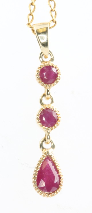 A 9ct yellow gold 3 stone ruby drop pendant and chain 
