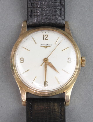 A gentleman's 9ct yellow gold Longines wristwatch on a leather strap 