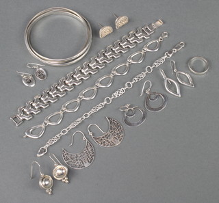 A silver bangle and 3 ditto bracelets together with 6 pairs of earrings and a ring, 144 grams