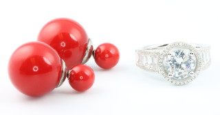 A pair of silver and red bead ear studs together with a silver and cubic zirconia ring 