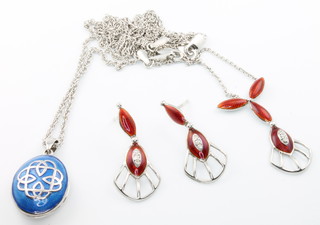 A Nicole Barr silver and enamelled pendant and chain and a red enamel, silver and diamond set pendant and earrings 