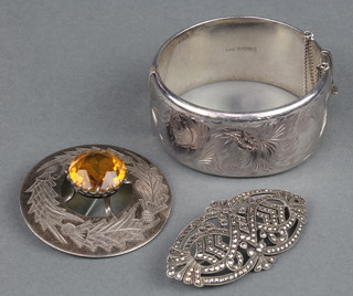 A silver bangle and 2 brooches, 92 grams