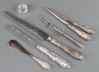 A silver handled bread knife, a pair of glove stretchers and minor cutlery 
