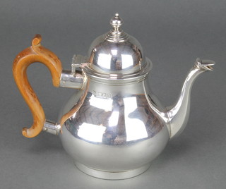 An Edwardian silver baluster teapot with fruit wood handle, London 1908, Maker C S Harris Ltd gross 362 grams