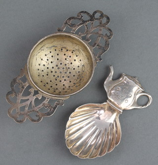 A novelty silver caddy spoon with teapot handle London 1949 and a ditto tea strainer 54 grams