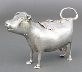 A fine George III silver cow creamer realistically modelled with chased hair the hinged lid with bee finial and flowers London 1784 Maker John Schuppe, 134 grams, 5.1/2"