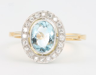 An 18ct yellow gold oval aquamarine and diamond ring, size O 1/2
