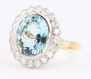 An 18ct yellow gold oval aquamarine and diamond ring, the centre stone approx 4.5ct surrounded by 20 brilliant cut diamonds approx. 0.6ct size O 1/2