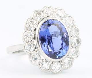 An 18ct white gold tanzanite and diamond oval ring, the centre stone approx. 2.5ct surrounded by 14 brilliant cut diamonds approx. 1.15ct size N 1/2