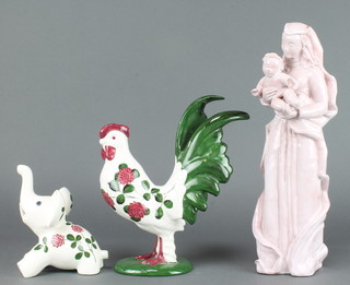A Plichta pink glazed figure of a woman and child 13 1/2" together, a Plichta figure of a cockerel 9 1/2" and a ditto of an elephant 5" with floral decoration 