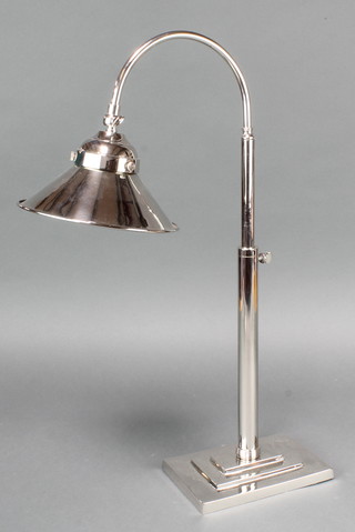 A silver plated adjustable students lamp on a rectangular stepped base 