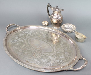 An Edwardian silver plated 2 handled tray with floral and scroll decoration a hot water jug, sauce boat and two dishes