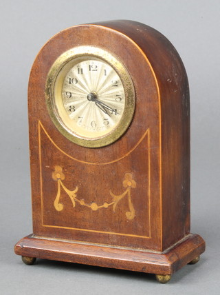 A German 1930's bedroom timepiece with silvered dial and Arabic numerals contained in an arched inlaid mahogany case 