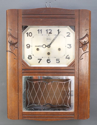 Veritable, A French Art Deco 8 day chiming wall clock with octagonal silvered dial and Arabic numerals contained in an oak case 
