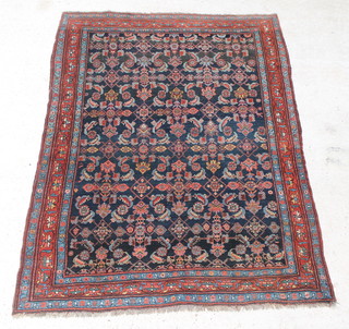 A blue ground Belouch rug with floral design within multi-row borders 83" x 58" 