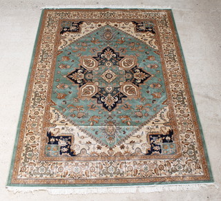A green and gold ground Belgian cotton Heriz Persian style carpet with central medallion 110" x 79" 