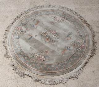 A circular cream ground and floral patterned Chinese rug decorated birds 63" diam. (some staining)