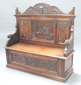 A Victorian carved oak settle, the back carved a man encountering a lion 55"h x 58"w x 19"d 