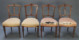 A set of 4 Victorian carved walnut slat and bar back dining chairs raised on turned and fluted supports 