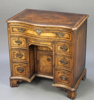 A Georgian walnut kneehole desk with quarter veneered and crossbanded top, fitted 1 long drawer above a secret drawer and cupboard enclosed by a panelled door flanked by 6 short drawers 28 1/2"h x 27 1/2"w x 18 1/2"d 