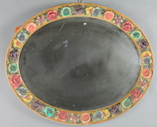 A 1930's oval bevelled plate wall mirror contained in barbola mounted frame 19" x 23 1/2"