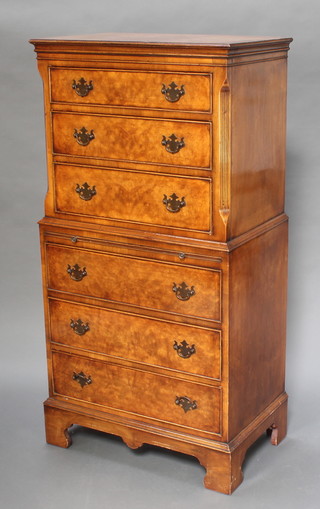 A Georgian style walnut chest on chest with moulded cornice, the upper section fitted 3 long drawers above a brushing slide, the base fitted 3 long drawers, raised on bracket feet 54"h x 27 1/2"w x 17"d 