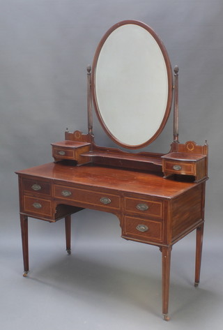 An Edwardian inlaid mahogany dressing table with oval bevelled plate mirror above 2 glove drawers the base fitted 1 long and 4 short drawers 60 1/2"h x 40"w x 22 1/2"d 
