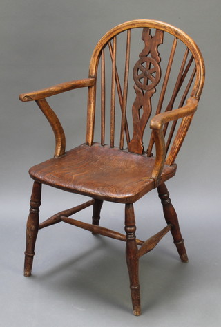 A 19th Century elm Windsor wheelback carver chair with solid seat and H framed stretcher, raised on turned supports 