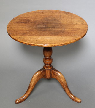 A circular oak wine table raised on a pillar and tripod base 18" x 18" diam. 