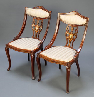 A pair of inlaid mahogany tub back salon chairs with pierced vase shaped slat backs, the seats of serpentine outline, raised on cabriole supports