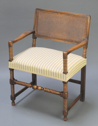 A beech framed carver chair with woven cane back raised on bobbin turned and block supports 