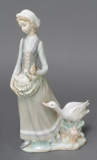 A Lladro figure of a goose girl 12"