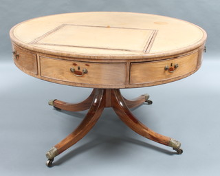 A Georgian mahogany drum table with inset brown leather top fitted a ratchet reading slope, having 8 frieze drawers, raised on a turned column tripod with brass caps and casters 29"h x 48 1/2" diam. 
