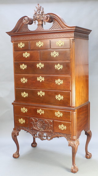 The Smithsonian Collection, a reproduction American high bonnet mahogany chest on stand, the upper section with broken pierced pediment and blind fret work frieze, fitted 3 short and 2 short drawers above a further 3 long drawers, the base fitted 1 long drawer above 3 short drawers, raised on cabriole supports.   The base with brass plaque marked Smithsonian chest of drawers reproduction number 23 1991, 86"h x 43"w x 21 1/2"d 