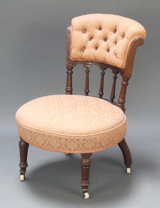 A Victorian walnut nursing chair with bobbin turned decoration raised on turned supports, the frame is loose 