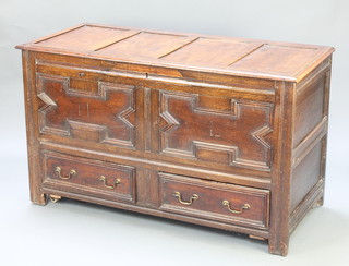 A 17th/18th Century mule chest of panelled construction with hinged lid and geometric mouldings, the base fitted 2 long drawers, the interior fitted a candle box, 30"h x 50 1/2"w x 22"d 