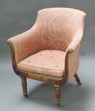 A William IV rosewood and brass inlaid show frame tub back armchair upholstered in patterned material, raised on turned fluted legs, brass caps and casters 