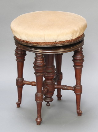 A Victorian circular revolving piano stool raised on turned supports 19" x 15" diam. 