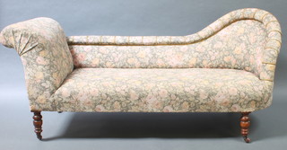 A Victorian chaise longue with raised back upholstered in tapestry material 29"h x 68"w x 25"d 