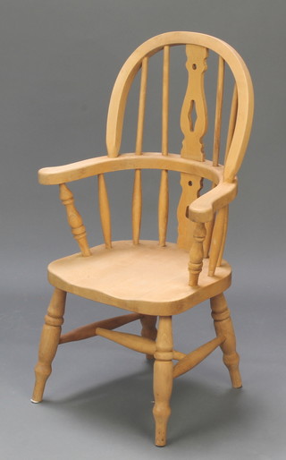 An 18th Century style pine Windsor stick back carver chair with solid seat raised on turned supports with H framed stretcher 