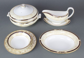 A Wedgwood Cornucopia pattern dinner service comprising 8 small plates, 8 dinner plates, 8 dessert bowls, 2 tureens and covers, a sauce boat and stand and an oval dish together with 8 similar dessert plates