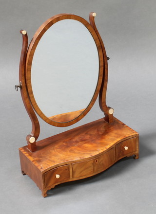 A Hepplewhite style oval plate dressing table mirror contained in a mahogany swing frame, the base of serpentine outline raised on bracket feet 20"h x 16"w x 7 1/2"d 