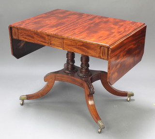 A Regency mahogany twin pillar pedestal sofa table fitted 2 drawers, raised on a triform base with splayed feet, brass caps and casters 28 1/2"h x 26" x 35 1/2" when closed x 59" when open 