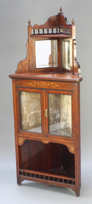A Victorian inlaid rosewood corner cabinet, the upper section with mirrored back the base fitted a cupboard enclosed by glazed panelled doors above a recess 61"h x 25"w x 15"d 