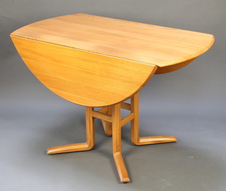 An Ercol light elm drop flap dining table raised on 4 chamfered supports 28"h x 44"w x 24 when closed x 48" when open 